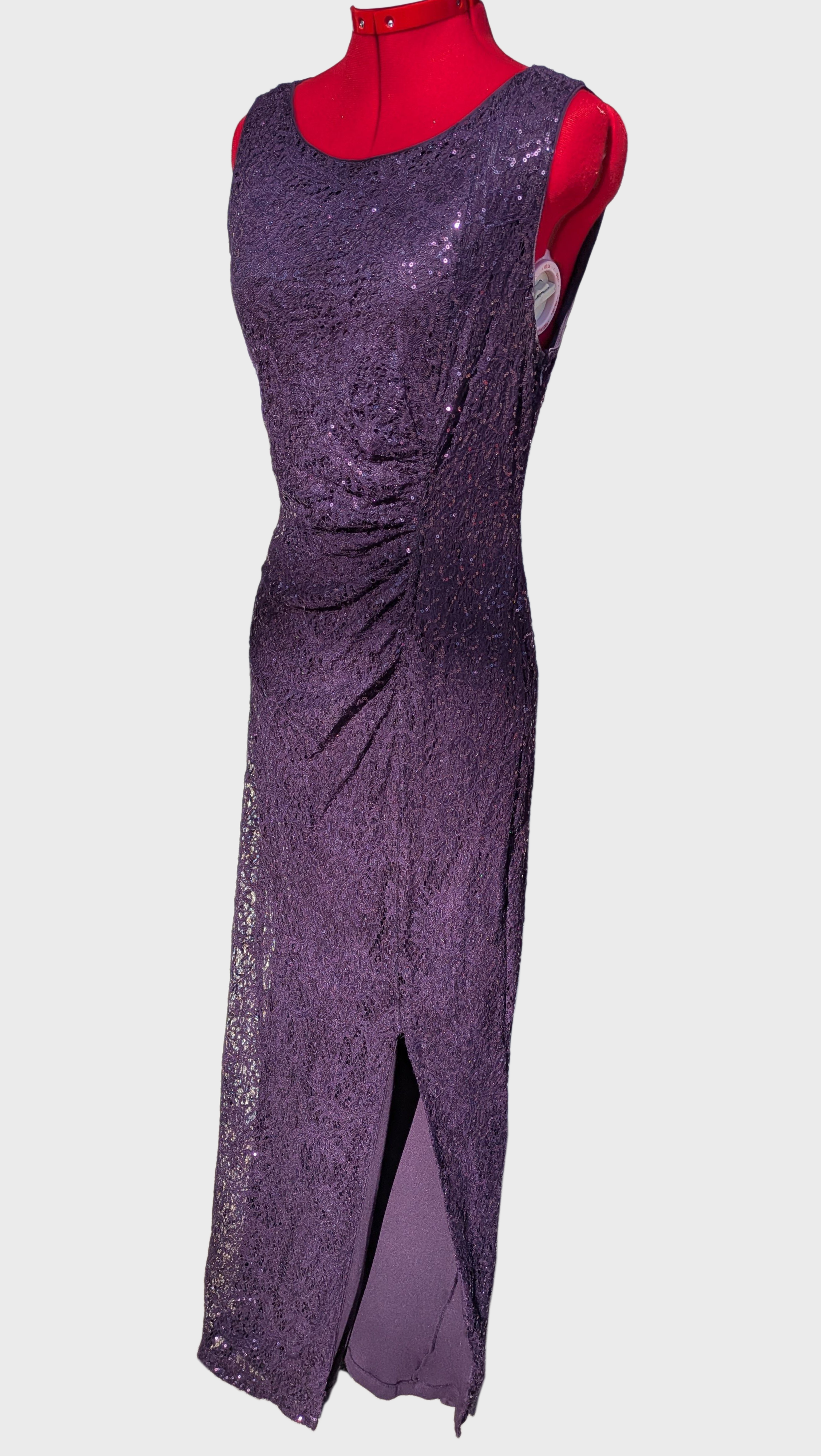 Long plum sequin dress on red mannequin against a white background